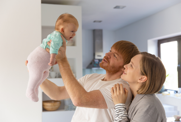 Calm parent soothing crying baby